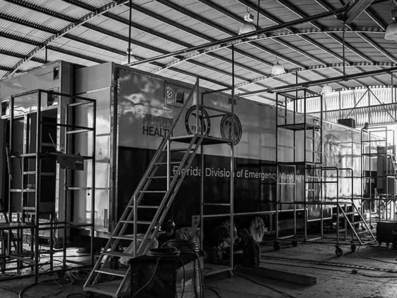 Modus business card — embossed cube mark on dark stock